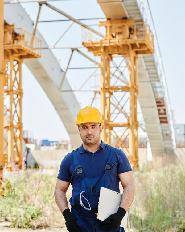 Tradesperson inspecting work on site with a checklist